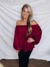 Top features a wine color, peasant sleeves, ruffled detail, elastic waist/ shoulder, loose fit, can be worn on or off the shoulder and runs true to size! 