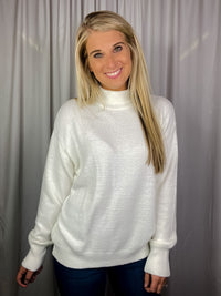 Sweater features a solid base color, long sleeves, round neck line and runs true to size!-cream