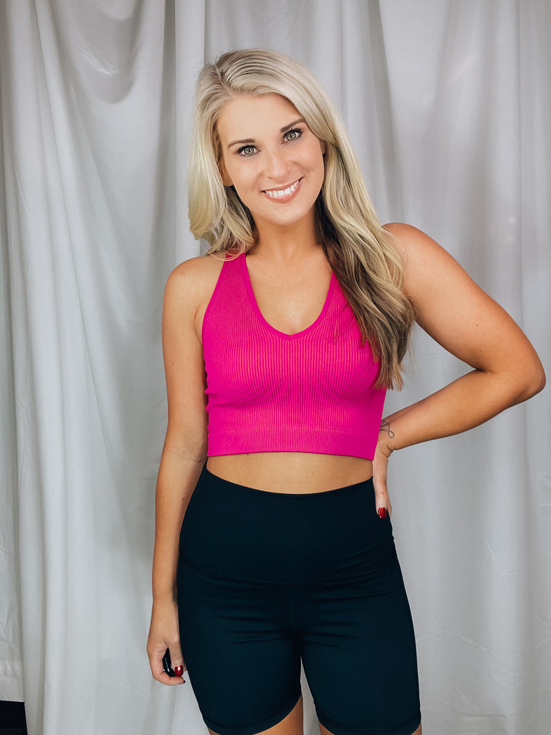 Top features a fitted fit, razor back detail, non padded top, ribbed stretchy material, cropped length and runs true to size!-MAGENTA