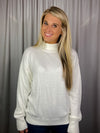 Sweater features a solid base color, long sleeves, round neck line and runs true to size!-cream