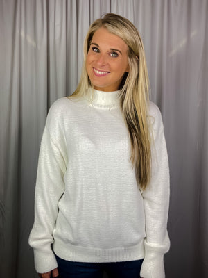 Sweater features a solid base color, long sleeves, round neck line and runs true to size!-cream