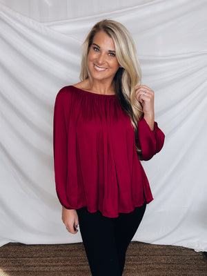 Top features a wine color, peasant sleeves, ruffled detail, elastic waist/ shoulder, loose fit, can be worn on or off the shoulder and runs true to size! 