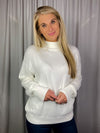 Sweater features a solid base color, long sleeves, round neck line and runs true to size!-cream