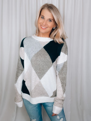 Sweater features a dreamy soft material, long sleeves, diamond pattern with hunter green/olive/grey and taupe tones, color block detail, crew neck line and runs true to size! 