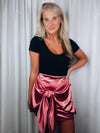 Skirt features a sweet pink color, front tie detail, mini length and runs true to size! 