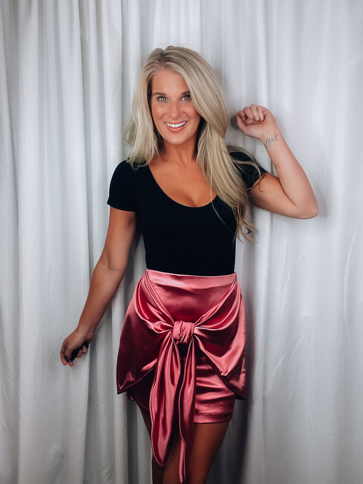 Skirt features a sweet pink color, front tie detail, mini length and runs true to size! 