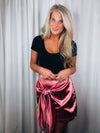 Skirt features a sweet pink color, front tie detail, mini length and runs true to size! 