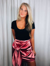 Skirt features a sweet pink color, front tie detail, mini length and runs true to size! 