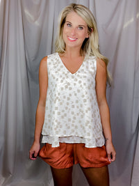 Top features an ivory base, taupe abstract print, V-neck line, sleeveless detail, layered bottom detailing and runs true to size! 