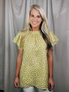Top features a solid base color, printed detail, ruffled short sleeve. mock detail, airy feel and runs true to size!-YELLOW