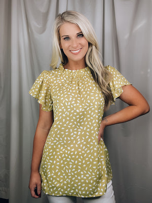 Top features a solid base color, printed detail, ruffled short sleeve. mock detail, airy feel and runs true to size!-YELLOW