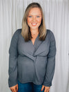 Top features a charcoal base, long sleeves, V-neck line, peplum fit, front knot detail, and runs true to size! 