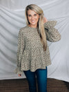 Top features a solid base color, paint stroke design, long sleeves, round neck, light weight material, cinched ruffle sleeves and runs true to size!   100% Polyester -SAGE