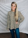 Top features a solid base color, paint stroke design, long sleeves, round neck, light weight material, cinched ruffle sleeves and runs true to size!   100% Polyester -SAGE