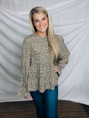 Top features a solid base color, paint stroke design, long sleeves, round neck, light weight material, cinched ruffle sleeves and runs true to size!   100% Polyester -SAGE