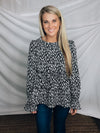 Top features a solid base color, paint stroke design, long sleeves, round neck, light weight material, cinched ruffle sleeves and runs true to size!   100% Polyester -BLACK