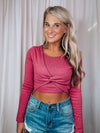 Top features a show stopping fuchsia color, cropped length, long sleeves, round neck line and runs true to size! 