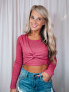 Top features a show stopping fuchsia color, cropped length, long sleeves, round neck line and runs true to size! 