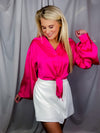 Top features a solid base color, lovely satin material, thin long sleeves, flattering V-neck line, front tie detail, and runs true to size!-hot pink