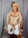 Top features a solid base color, lovely satin material, thin long sleeves, flattering V-neck line, front tie detail, and runs true to size! -mocha