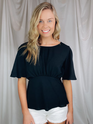 Top features a solid base color, boat neck, short sleeves, ruched front, textured material and runs true to size!-BLACK