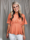 Top features a solid base color, boat neck, short sleeves, ruched front, textured material and runs true to size!-PEACH