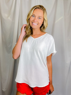 Top features a solid base color, flattering V-neck line, short sleeves and runs true to size!