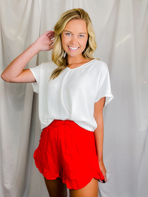 Top features a solid base color, flattering V-neck line, short sleeves and runs true to size!