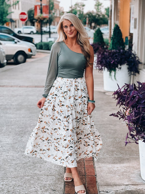 Skirt features a white base, mustard and green floral print, elastic waist, underlining, maxi length and runs true to size! 