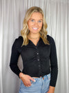 Top features a solid base color, long sleeves, button down detail, hip length, collared detail and runs true to size!-black