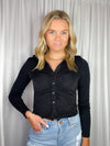 Top features a solid base color, long sleeves, button down detail, hip length, collared detail and runs true to size!-black