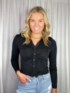 Top features a solid base color, long sleeves, button down detail, hip length, collared detail and runs true to size!-black