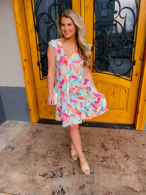 The Deeper Connection Dress features short ruffle sleeves, vibrant coloring, and functional button down detailing, which provide figure-flattering elements. Further enhancing this look, a tiered skirt and V-neck line combine to provide an eye-catching and stylish look.
