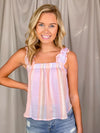 Top features a multi colored striped print, ruffle straps, elastic chest, light weight material, tie bow back detail and runs true to size!   Material:  63% Rayon / 37% Polyester 