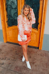 This paisley print top bring our your inner retro side. Top features a fun pink/orange coloring, oversized fit, long cuff sleeves, collar detail, functional button down closure and runs very oversized.