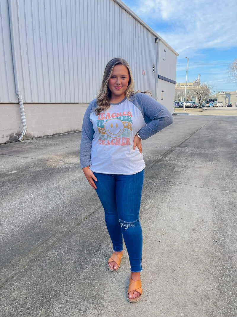 Welcome to school in (style)! Show your teacher pride with this adorably quirky Teacher Smile Face Raglan. The 3/4 sleeves and fun design will keep you looking your best while feeling totally carefree. Let your inner teacher shine with this unique look — you'll be fetching 'A's all year long! (No detention required.)  Printed on our unisex loose fitting raglans