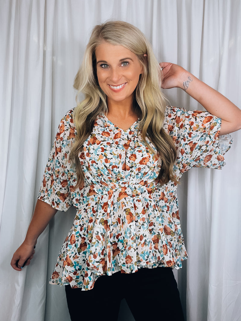 Top features a light base, multi color floral print, short kimono sleeves, V-neck line and runs true to size!   *Is a tad sheer so we recommend wearing only a nude bra* 