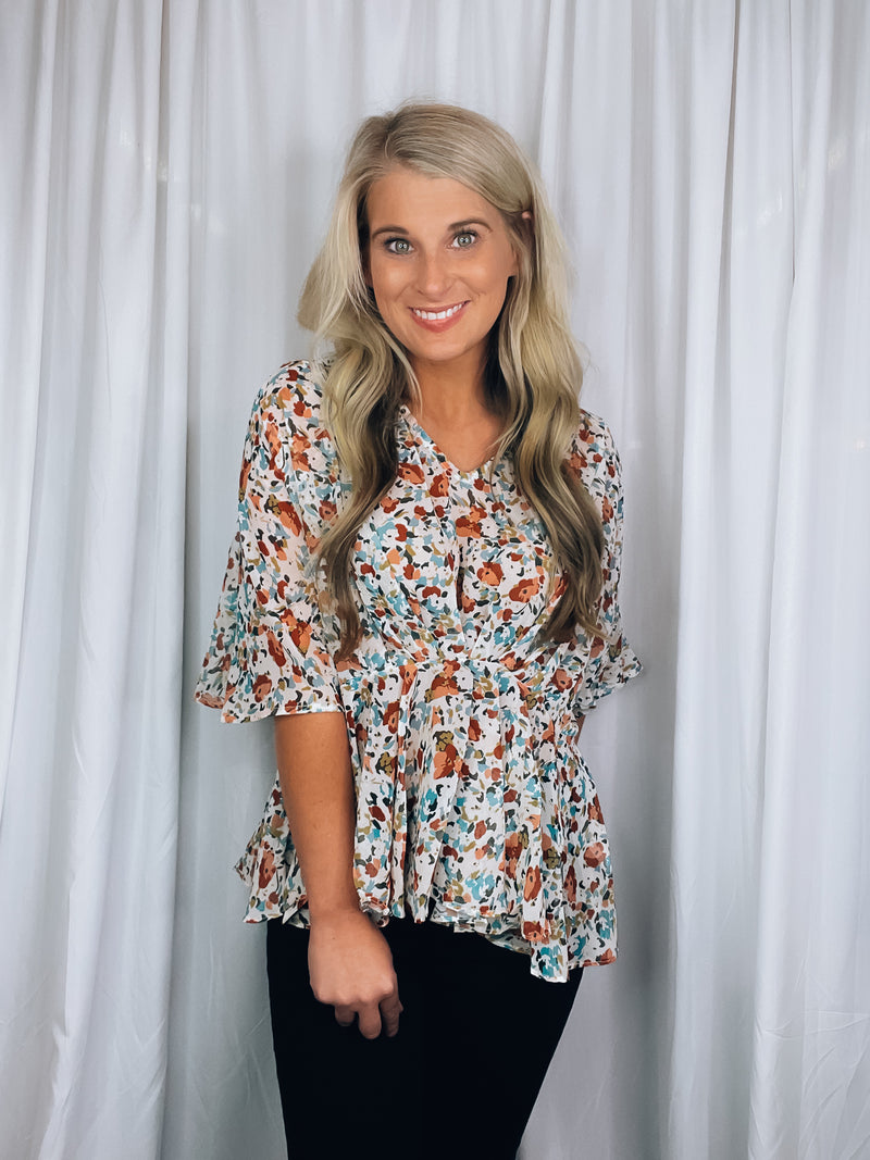 Top features a light base, multi color floral print, short kimono sleeves, V-neck line and runs true to size!   *Is a tad sheer so we recommend wearing only a nude bra* 