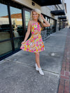 Dress features a fun multi color dress, halter neck, mini length, cut-out front, and runs true to size! 