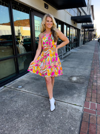 Dress features a fun multi color dress, halter neck, mini length, cut-out front, and runs true to size! 