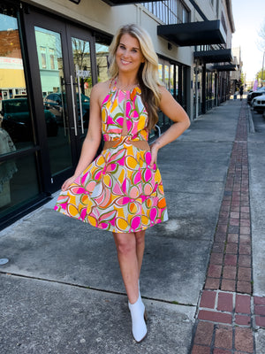 Dress features a fun multi color dress, halter neck, mini length, cut-out front, and runs true to size! 