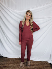 This lounge set features a solid base color, soft material, top with a V-neck line and long sleeves, jogger high waisted pants, surplus pockets with a drawstring and runs true to size!-MARSALA