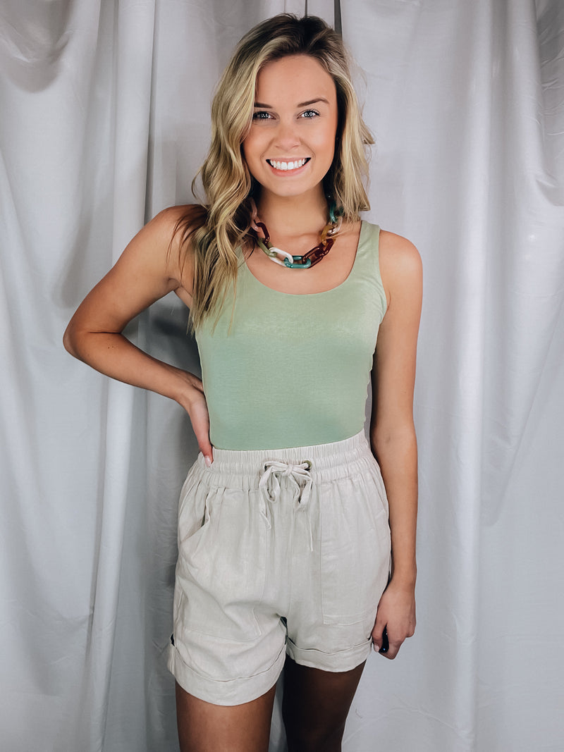 Bodysuit features a simple and flattering scoop neck with a soft, stretchy material.-sage