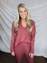 This lounge set features a solid base color, soft material, top with a V-neck line and long sleeves, jogger high waisted pants, surplus pockets with a drawstring and runs true to size!-MARSALA