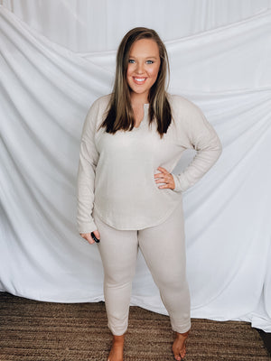 This lounge set features a solid base color, soft material, top with a V-neck line and long sleeves, jogger high waisted pants, surplus pockets with a drawstring and runs true to size!-KHAKI