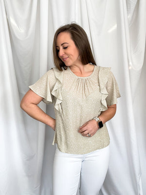 Top features a light taupe base, small white spotted detail, ruffle front detailing, short sleeves, round neck line, lightweight material and runs true to size! 