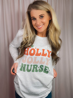 Graphic features a light colored tee, long sleeves, nurse Christmas design, unisex fit and runs true to size! 