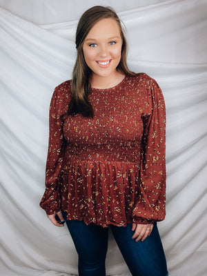 This top features a solid base color, long sleeves, mini floral print, flattering, round neck line, and runs true to size! -BRICK