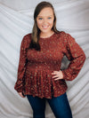 This top features a solid base color, long sleeves, mini floral print, flattering, round neck line, and runs true to size!-BRICK