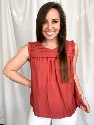 Top features a solid base color, sleeveless detail, round neck line, detailing on the chest, lightweight material and runs true to size!-marsala